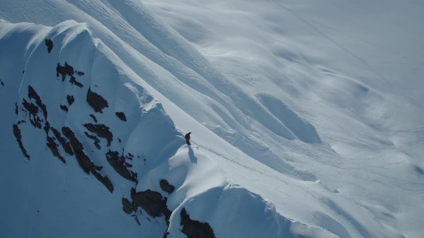 An aerial clip of a slopy arctic mountain