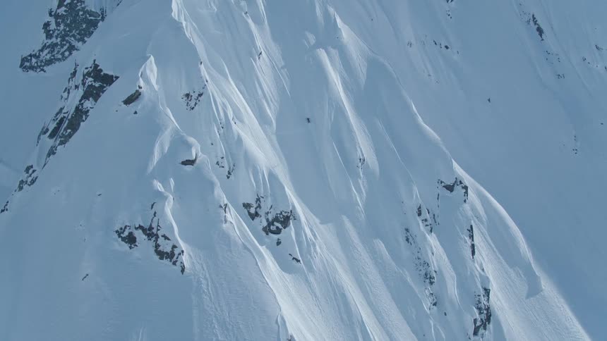 Person climbing a snowy mountain