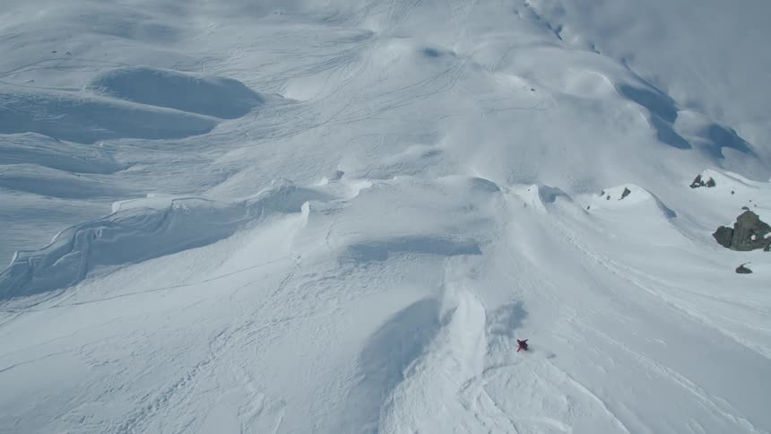 Person skiing down a snowy mountain