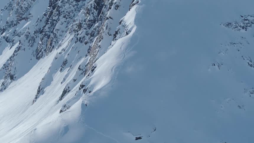 Person skiing down a snowy mountain