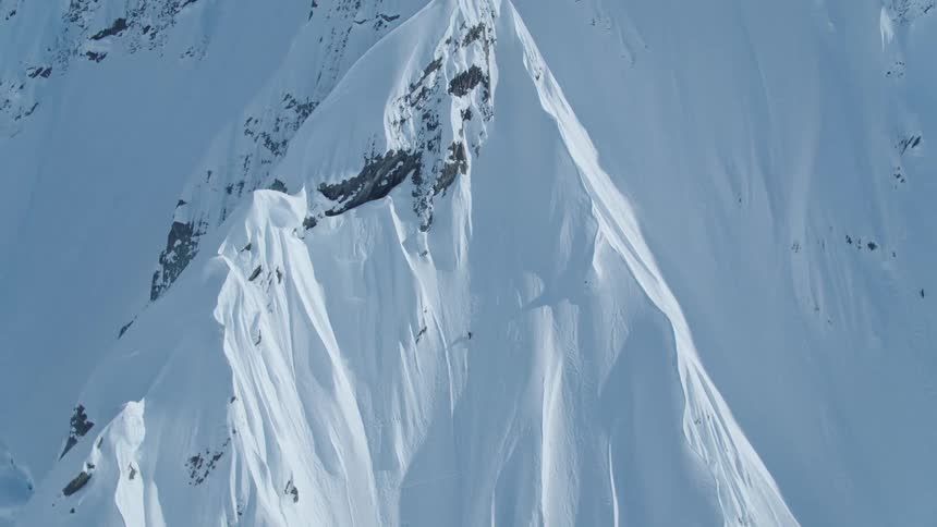 Isolated person climbing a snowy mountain