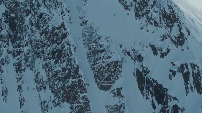 Aerial view of a person skiing down a snowy mountain