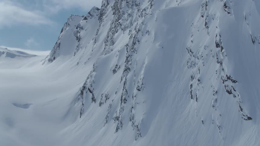 Aerial view of a person skiing down a snowy mountain