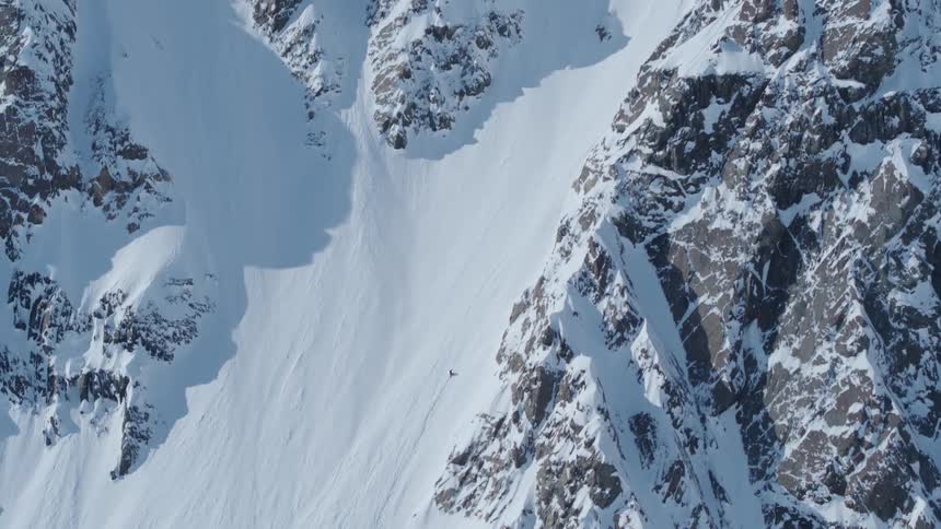 Isolated person climbing a snowy mountain
