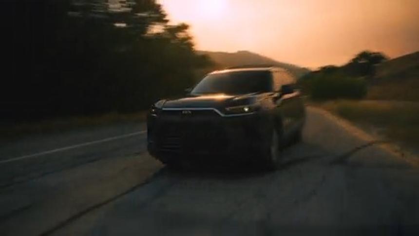 SUV races toward camera and then swerves right under smoky sky