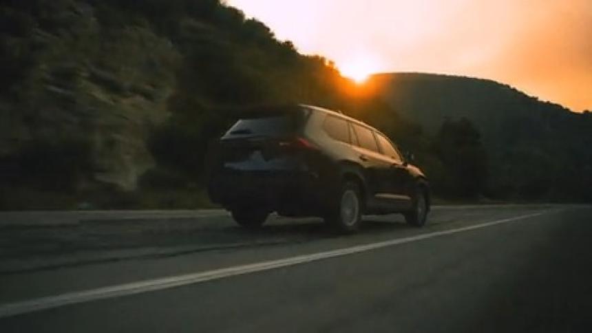 Family vehicle driving down long road