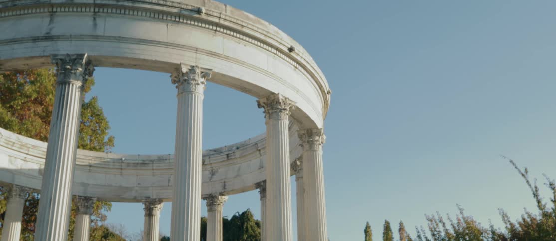 Greek column with trees around