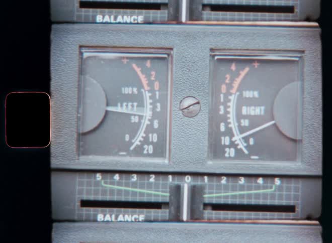 A close up of an audio mixers balance control and leftright level meters