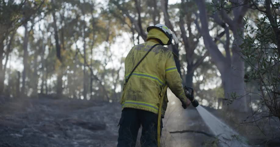 A clip of a firefighter wetting the ground