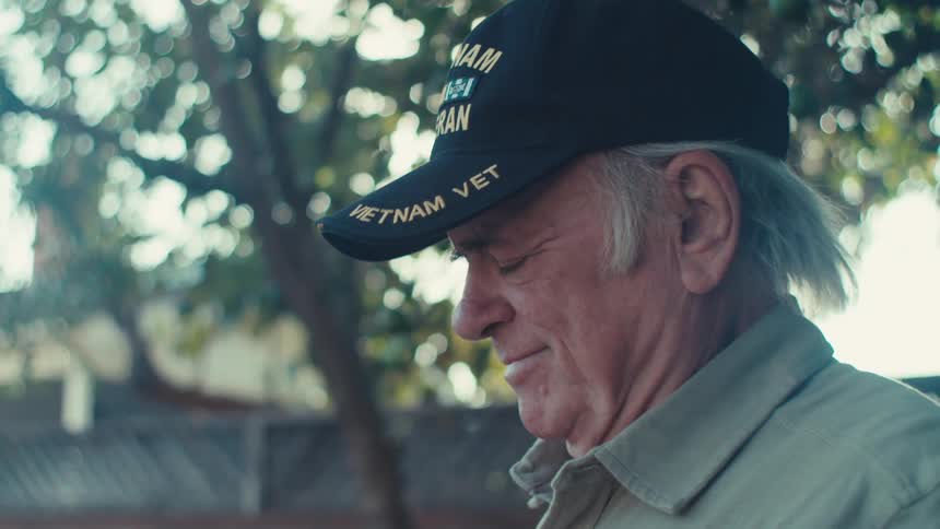 A clip of an old man raising a flag