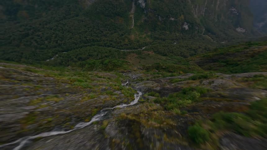 FPV Drone Dive Following a Mountain Stream Down the Mountain