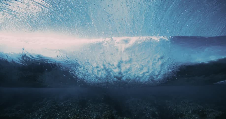 Underwater view of a wave rolling over a reef