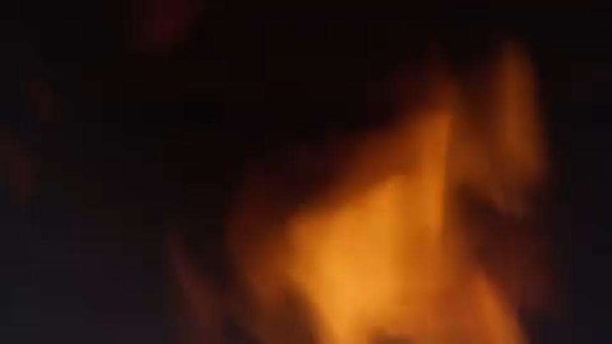 Flames of fire rising in an outdoor environment at night