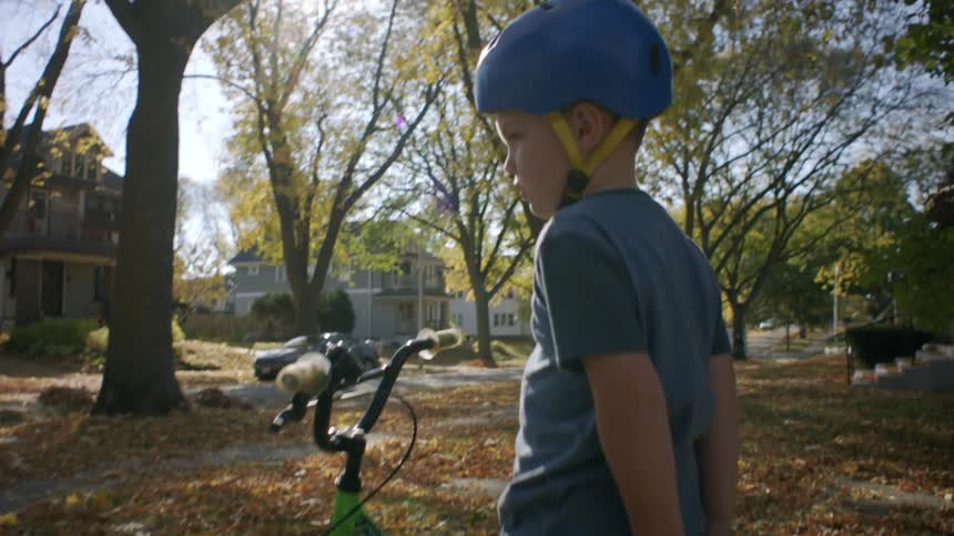 Little boy sitting on a bicycle