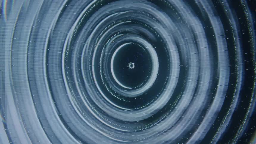 A series of faint glowing concentric circles radiating outwards