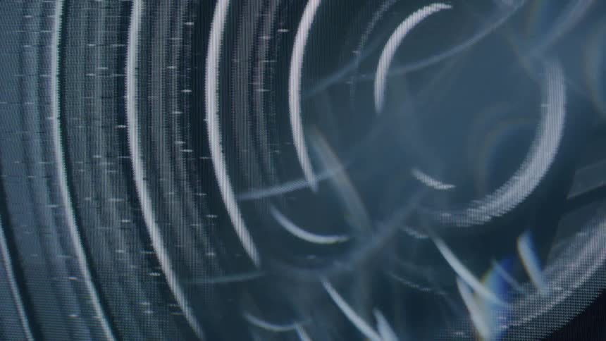 Abstract wavy lines in patterned motion against a black background