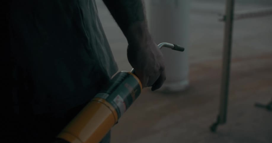 Close up of a persons hand walking and holding a blowtorch