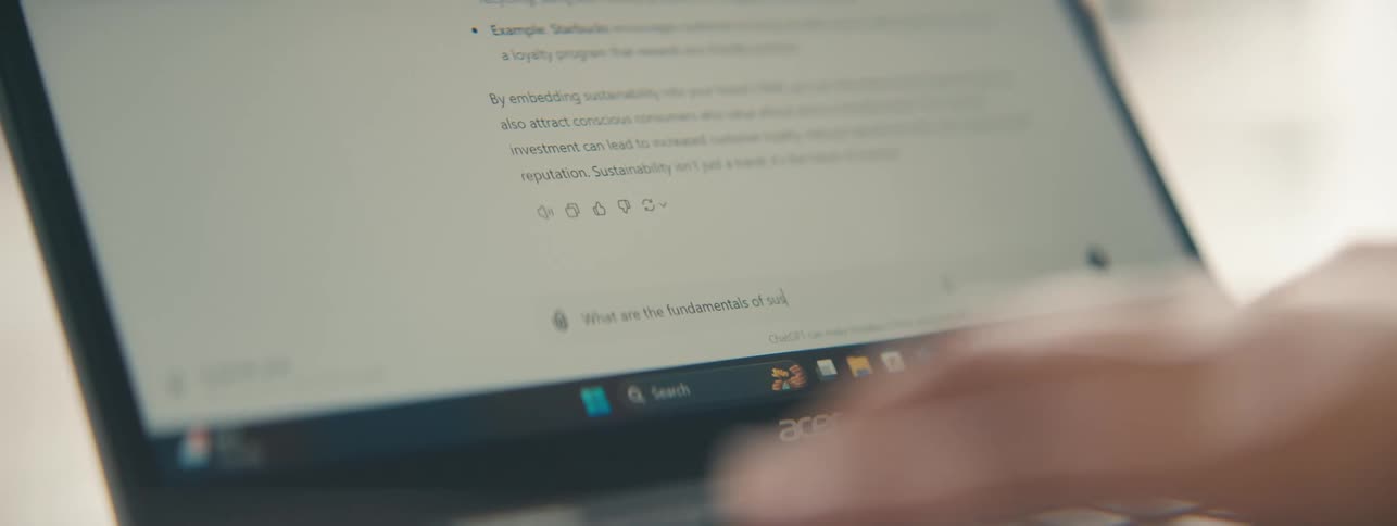 Hands typing on a laptop