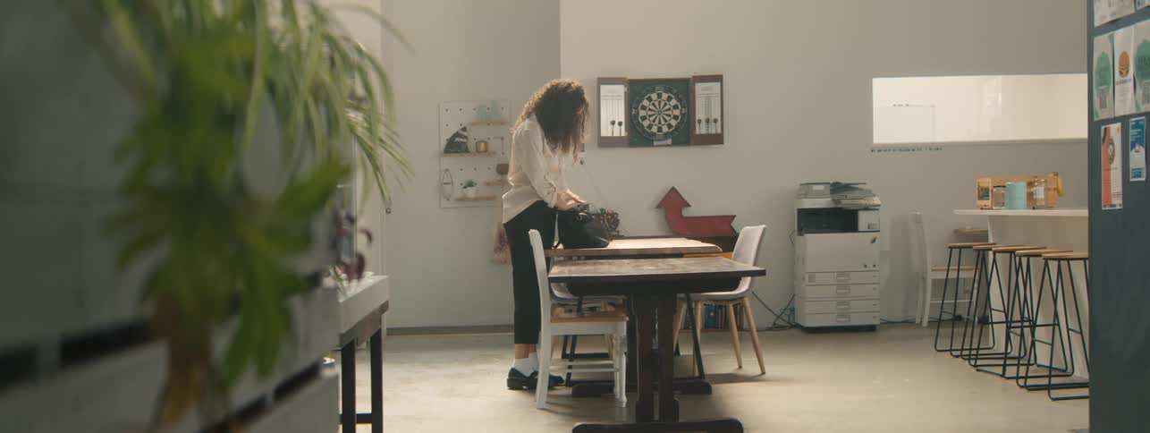 Woman storing her belongings while in an office environment