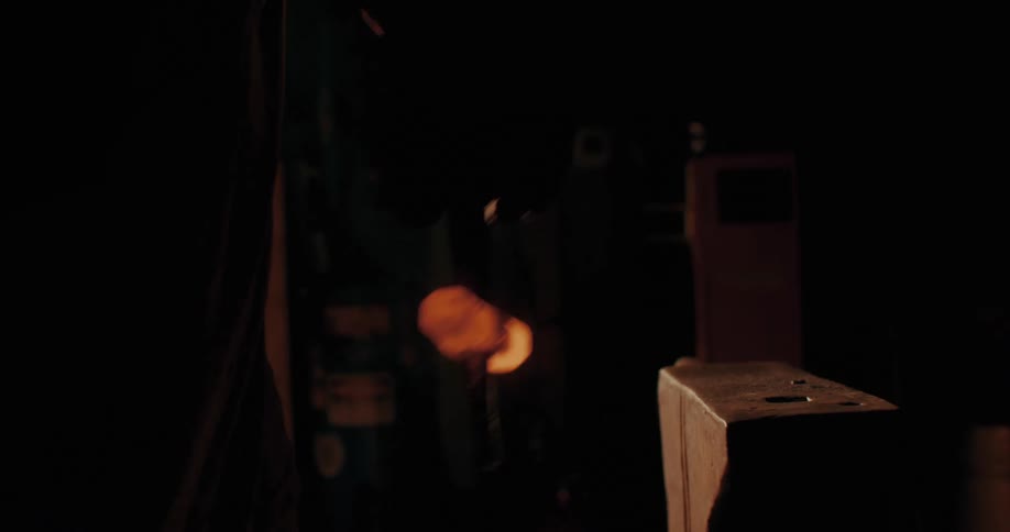 A blacksmith creates a hammer with hot metal