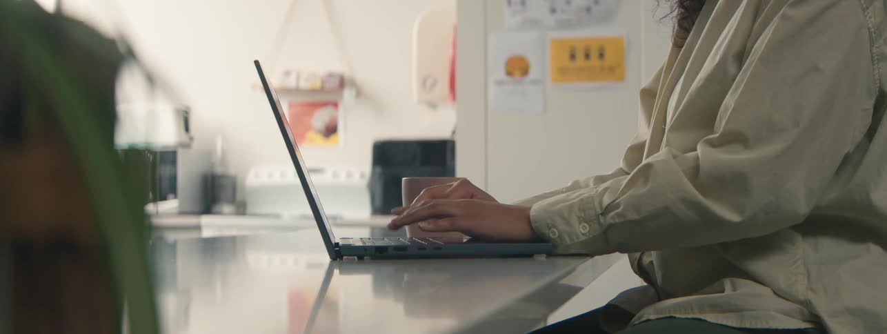 A person typing on a laptop computer
