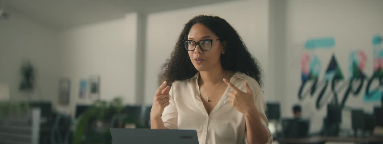 Woman interacting with her laptop in an office environment