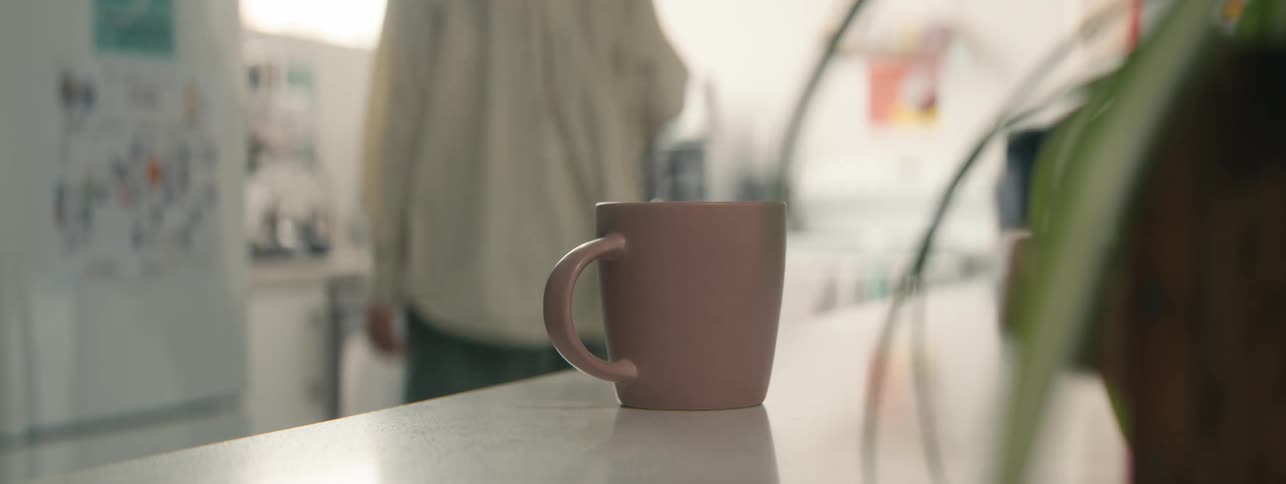 Person serving themselves with coffee in a cup