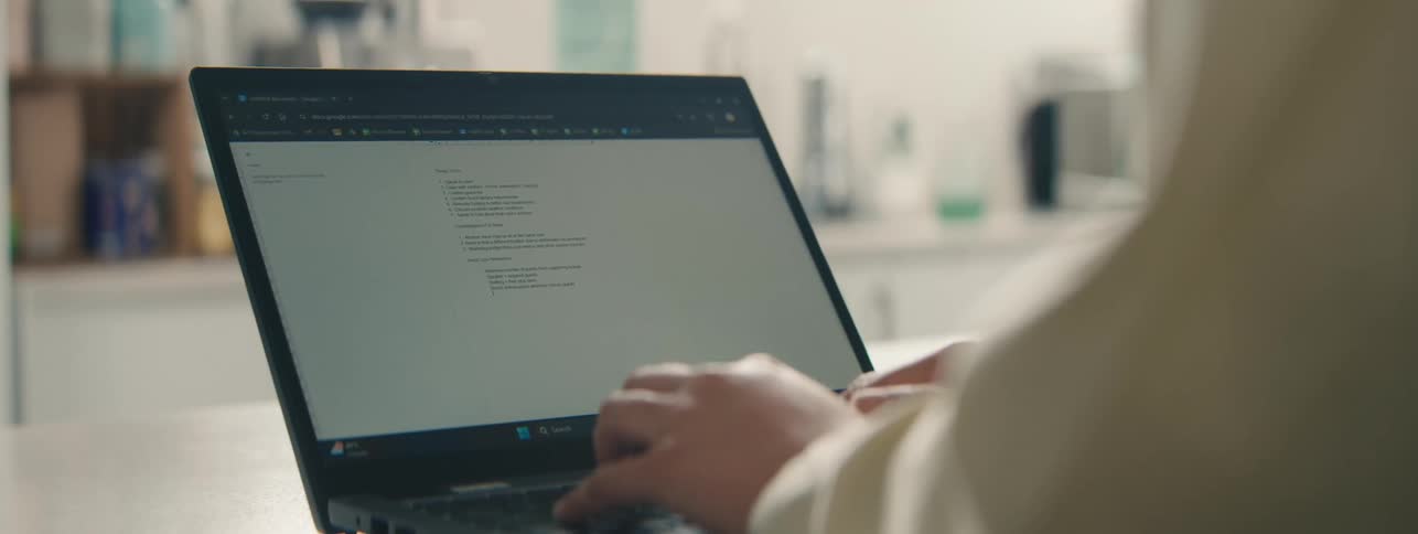 A person typing on a laptop computer