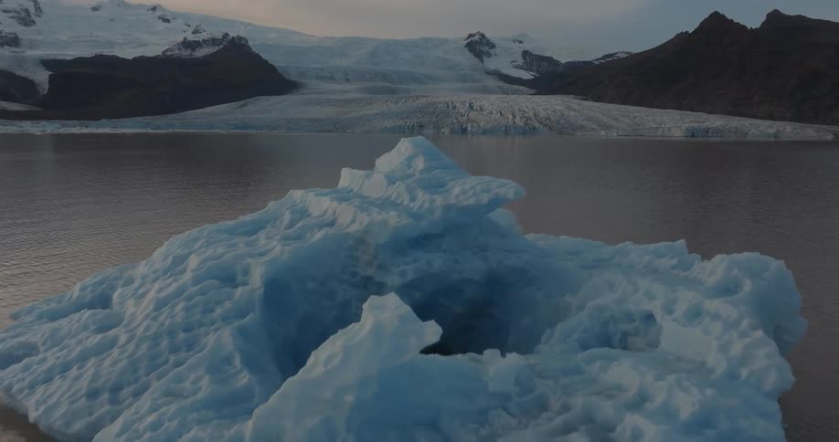 A large iceberg is by the shore