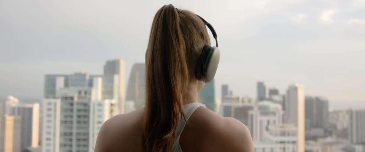 View of a woman from behind using a gray headset