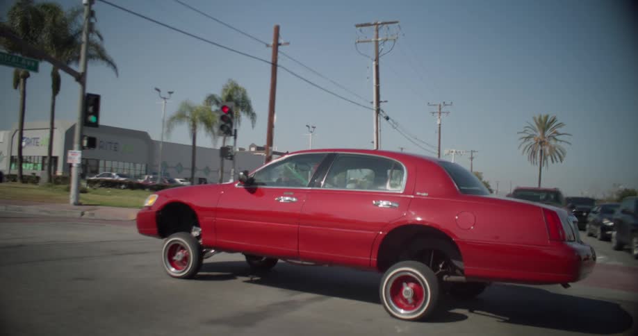 Vintage red car moving around the city with sports springs
