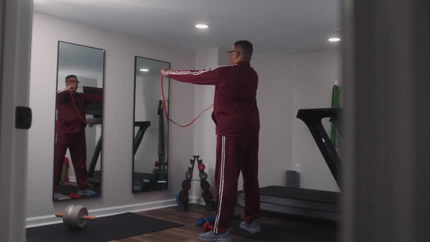 Man stretching his arms with a resistance band