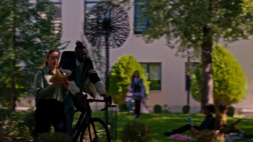 A man rides his bike through the park