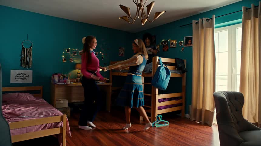 Two girls dance together in their shared bedroom
