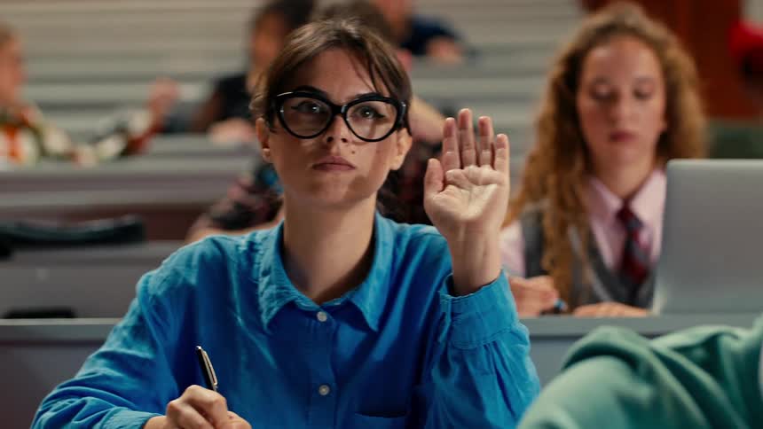 Students in a classroom raising their hands