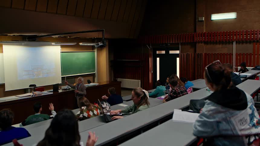 Students in the classroom while the teacher gives a lecture