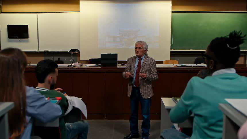 A teacher gives a lecture to students in a college classroom