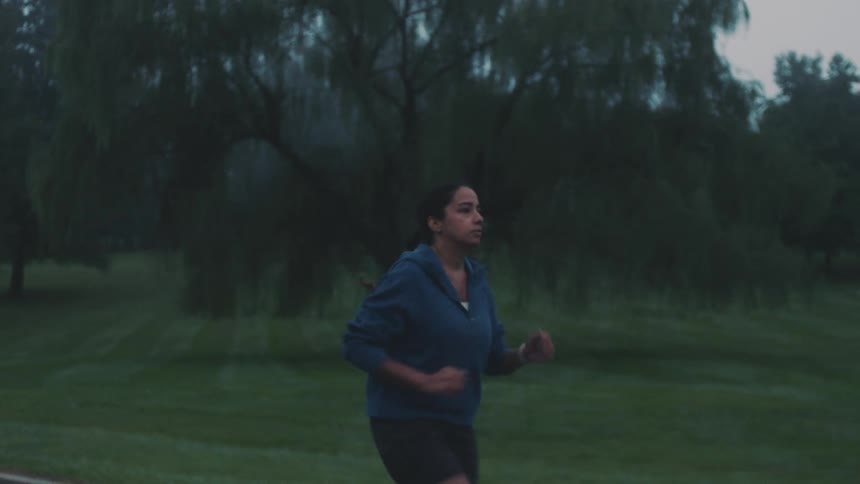 Woman running on a cloudy day