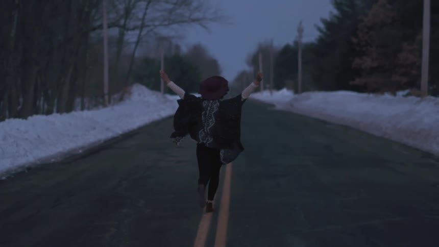 Person running down the double yellow of a road