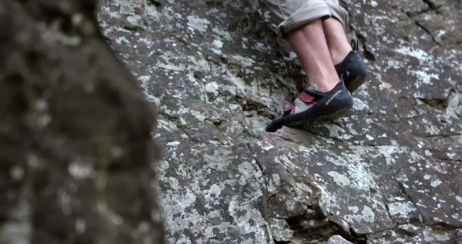 A rock climber climbing up a cliff