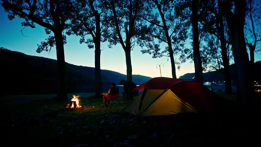 A night clip of two people in a camp