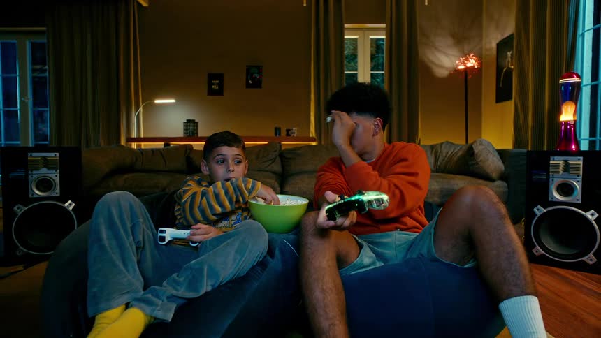 A clip of brothers playing a console game in the living room
