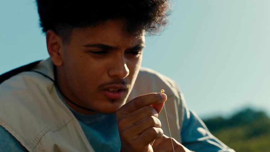 Teenager having fun holding a fishing hook