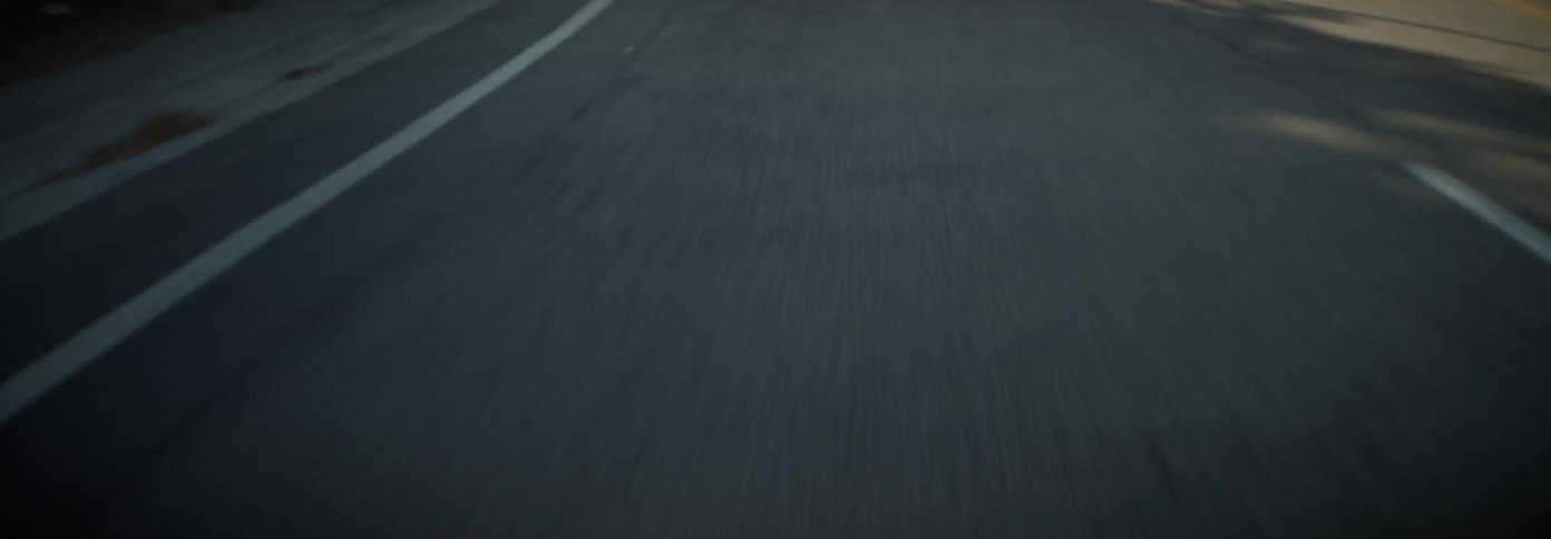 Moving view of a paved road seen during the day