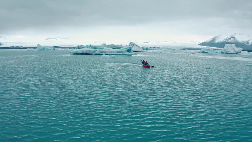 A clip of two people on a boat in the arctic