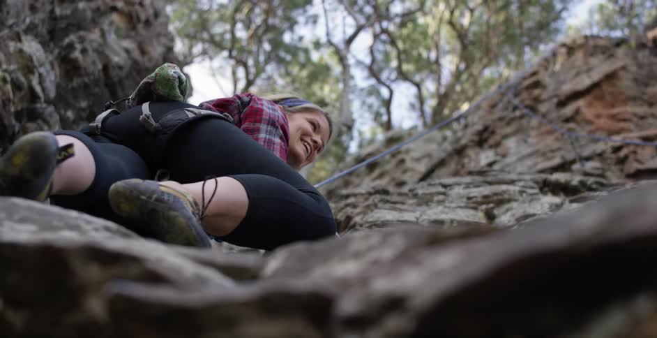 A rock climber climbing up a cliff