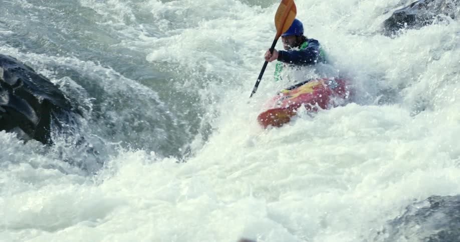 Man kayaking down white water rapids