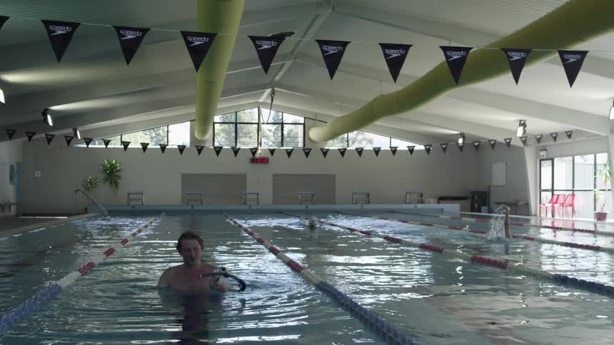 Man swimming in pool with a snorkel