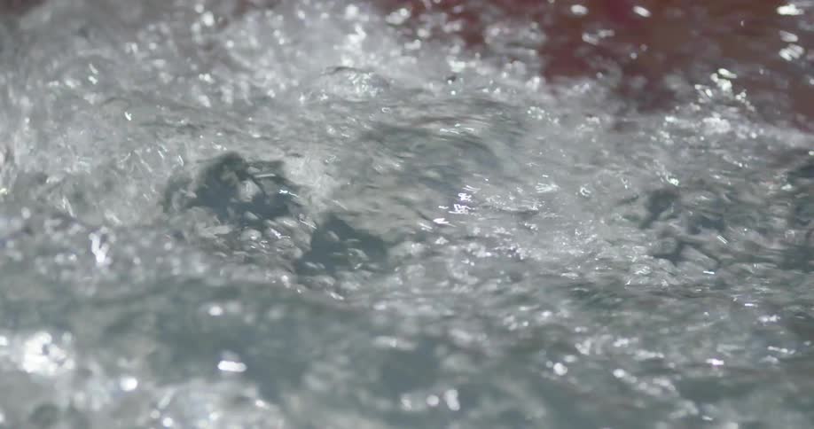 A boat oar going through rough water