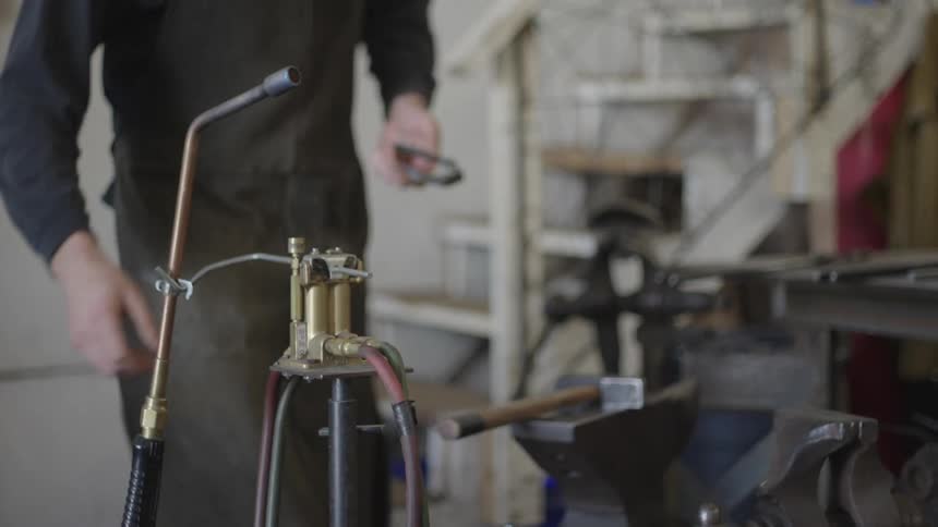 A person lights a blowtorch